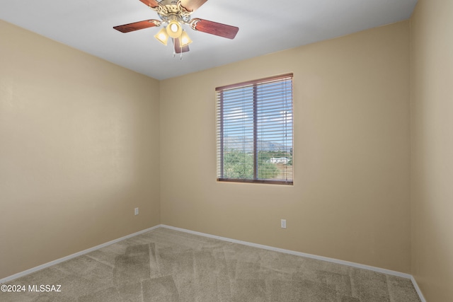 carpeted spare room with ceiling fan