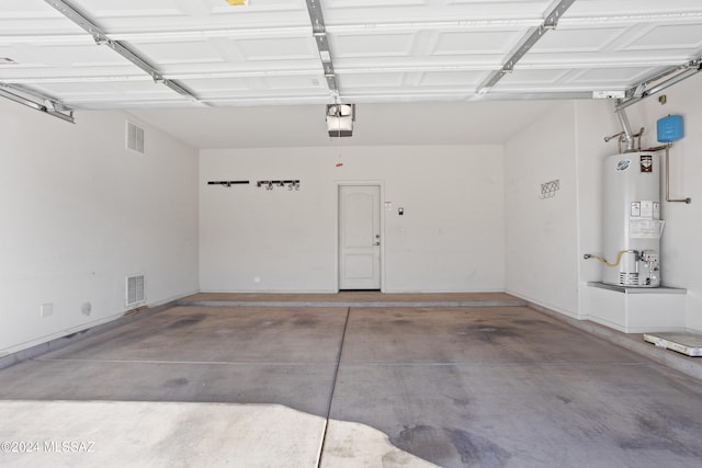 garage featuring gas water heater and a garage door opener