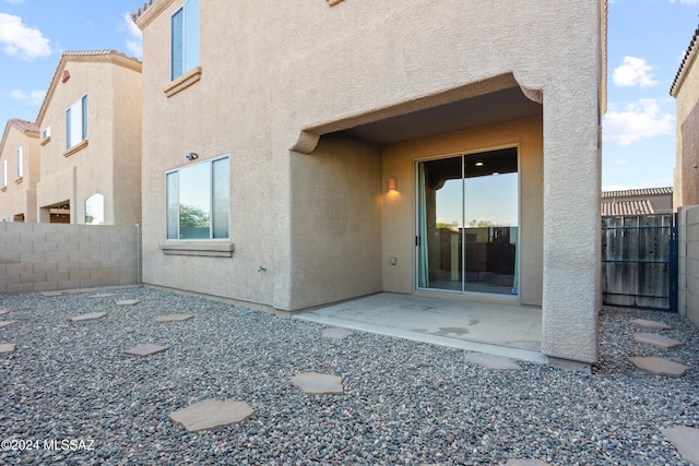 back of property with a patio