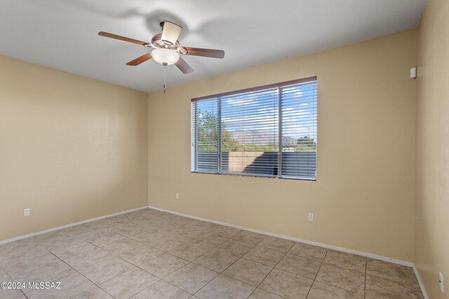 tiled empty room with ceiling fan