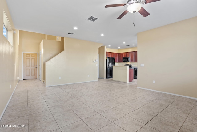 unfurnished living room with light tile patterned flooring and ceiling fan