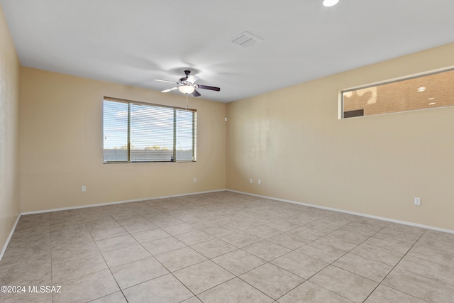 unfurnished room with ceiling fan and light tile patterned floors