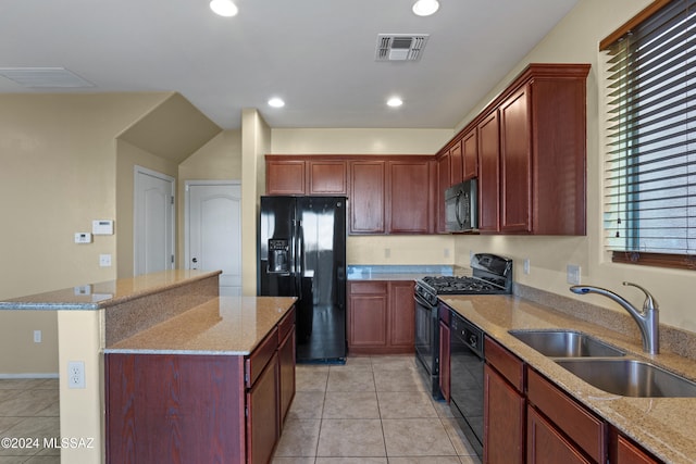 kitchen with light tile patterned flooring, black appliances, sink, and light stone countertops