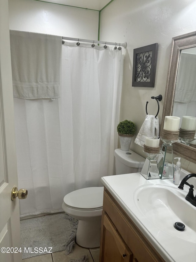 bathroom with tile patterned flooring, vanity, and toilet