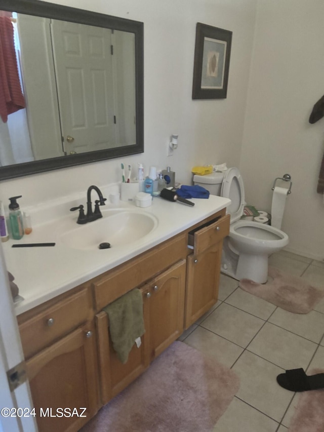 bathroom with vanity, tile patterned flooring, and toilet