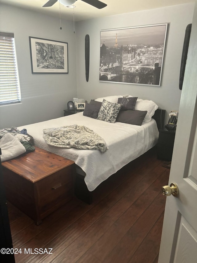 bedroom with ceiling fan and dark hardwood / wood-style floors