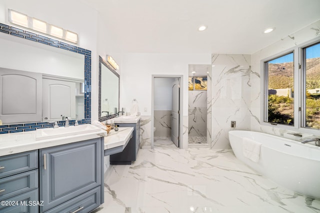 bathroom with tile walls, independent shower and bath, and vanity