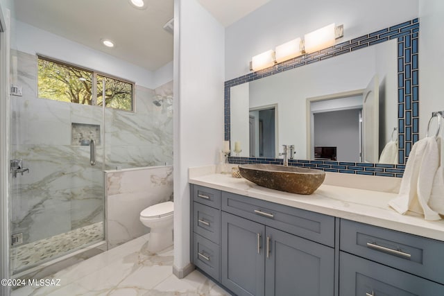 bathroom with vanity, toilet, and a shower with shower door