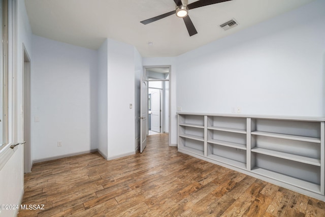 spare room with wood-type flooring and ceiling fan