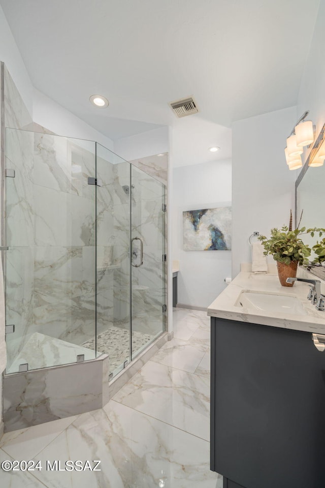 bathroom featuring vanity and a shower with door