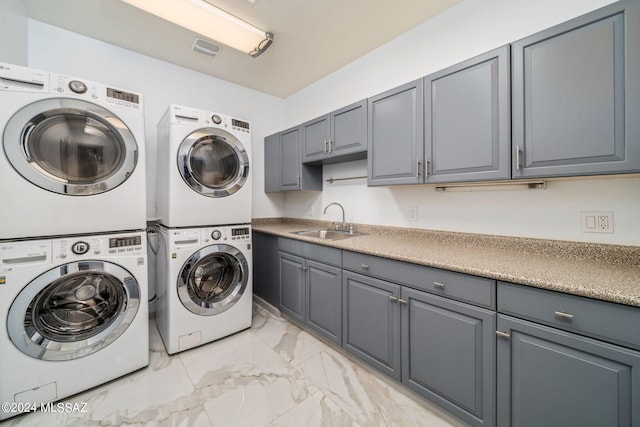 clothes washing area with cabinets, stacked washer and dryer, independent washer and dryer, and sink