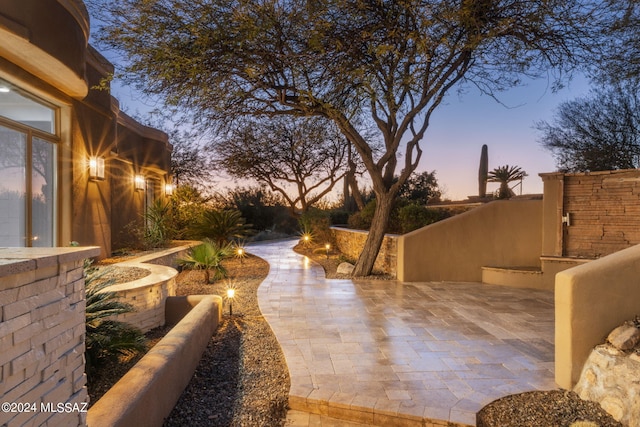 view of patio terrace at dusk