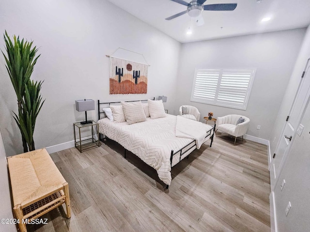 bedroom with ceiling fan and light hardwood / wood-style flooring