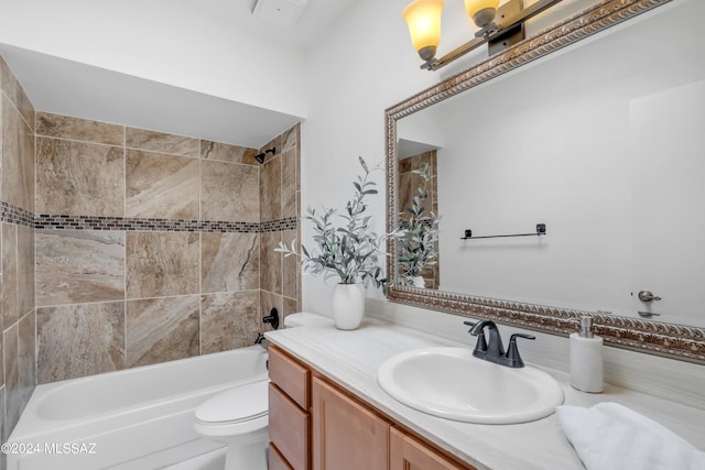 full bathroom featuring toilet, vanity, and tiled shower / bath