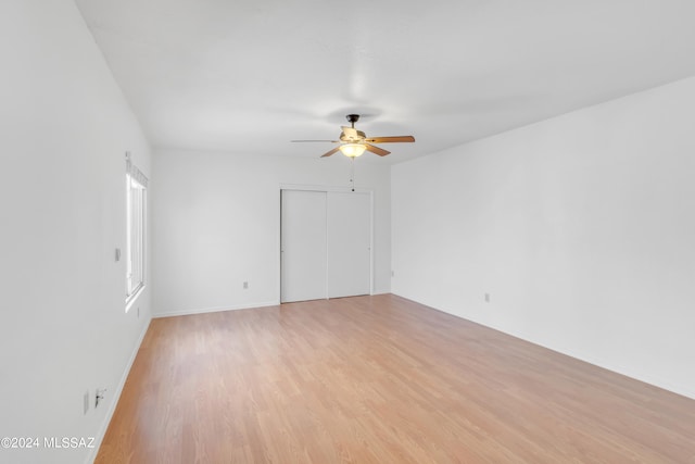 unfurnished room featuring light hardwood / wood-style flooring and ceiling fan