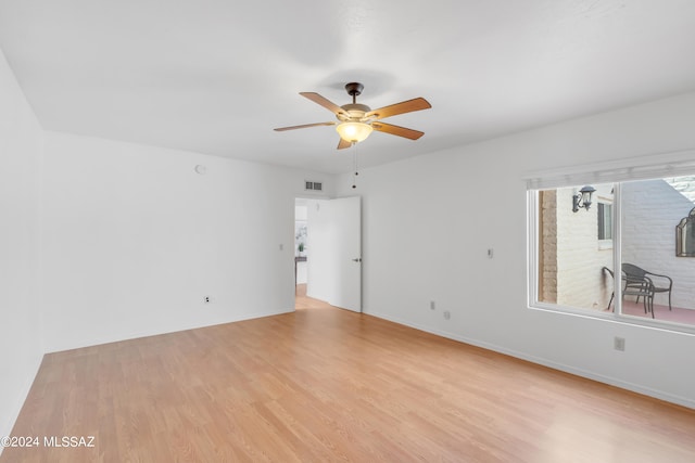 empty room with light hardwood / wood-style flooring and ceiling fan