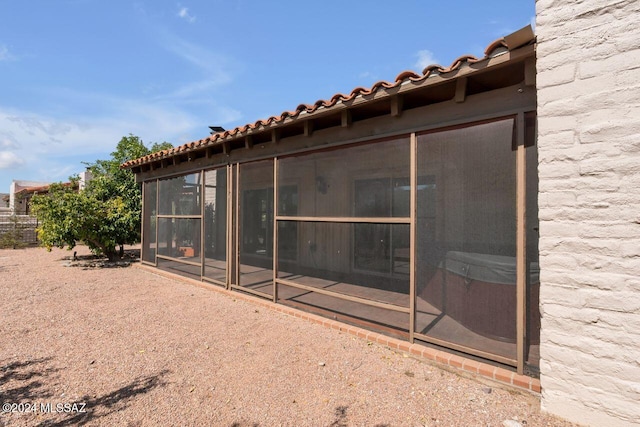 rear view of property with a sunroom