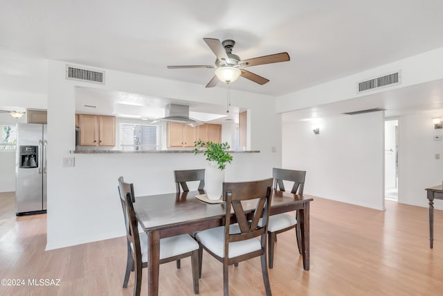 dining room with light hardwood / wood-style flooring and ceiling fan