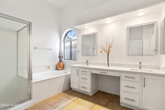 bathroom with independent shower and bath, vanity, and tile patterned flooring