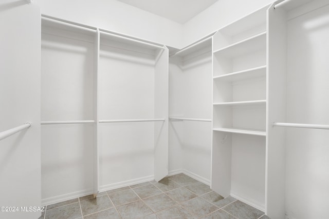 walk in closet featuring light tile patterned floors