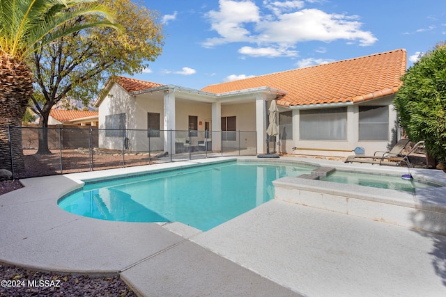 view of pool with an in ground hot tub and a patio