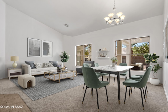 dining area featuring lofted ceiling, a notable chandelier, and plenty of natural light