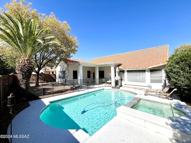 view of pool with an in ground hot tub and a patio area