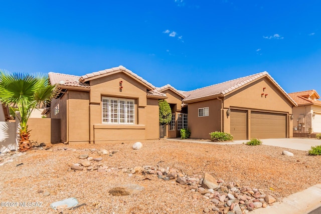 64384 E Round Robin Ln, Saddlebrooke, AZ 85739 - view of front facade with a tile roof, a garage, stucco siding, fence, and concrete driveway