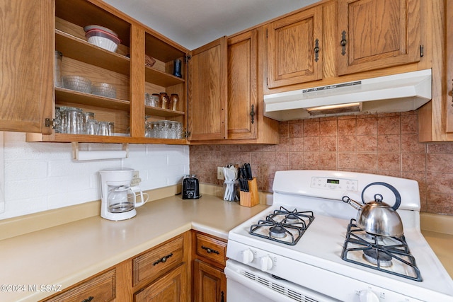 kitchen with white range with gas stovetop and backsplash