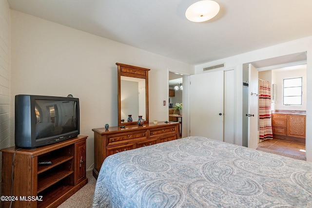 bedroom featuring ensuite bath