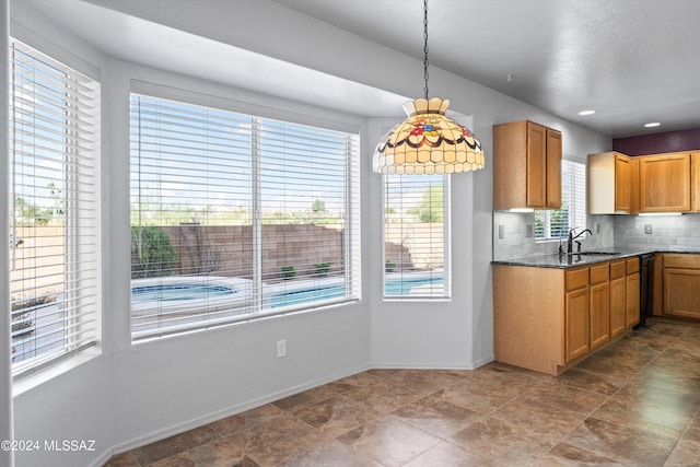 kitchen featuring backsplash, sink, and pendant lighting