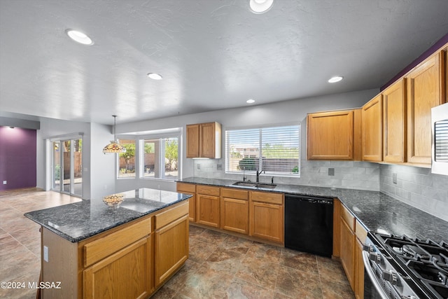 kitchen with black dishwasher, sink, hanging light fixtures, decorative backsplash, and dark stone countertops