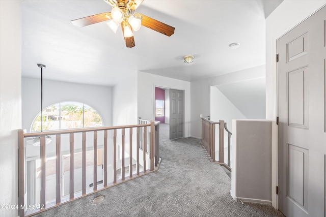 hallway with dark colored carpet