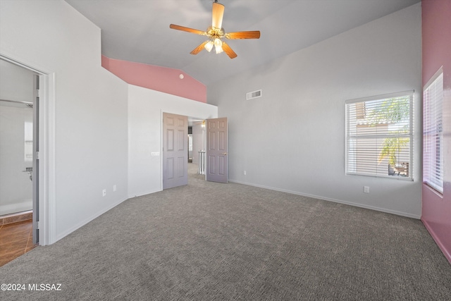 unfurnished bedroom with ceiling fan, carpet flooring, and high vaulted ceiling