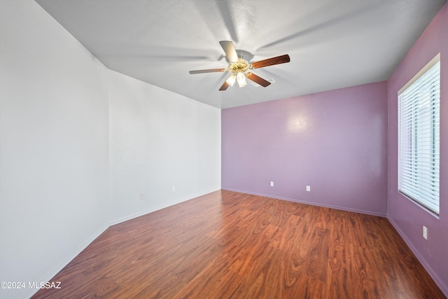 empty room featuring ceiling fan and dark hardwood / wood-style floors