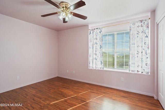 unfurnished room with ceiling fan and dark hardwood / wood-style floors