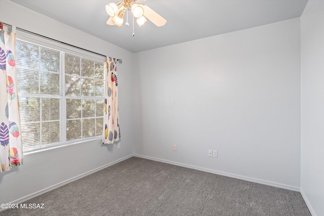 carpeted empty room featuring a healthy amount of sunlight and ceiling fan