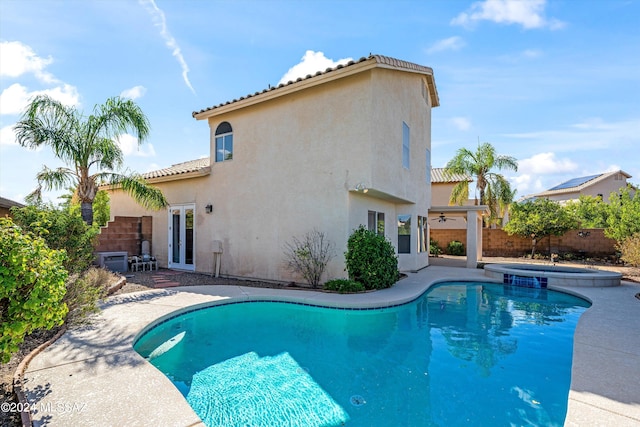 view of swimming pool featuring a patio and an in ground hot tub