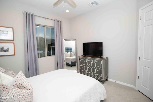 bedroom featuring light carpet and ceiling fan