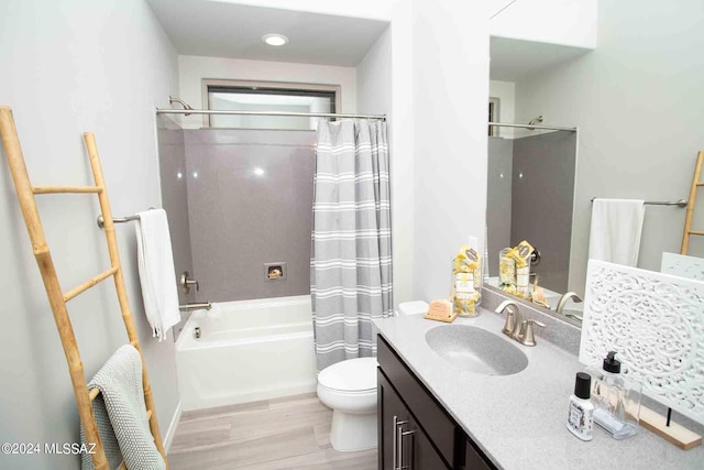 full bathroom featuring shower / tub combo, hardwood / wood-style floors, vanity, and toilet