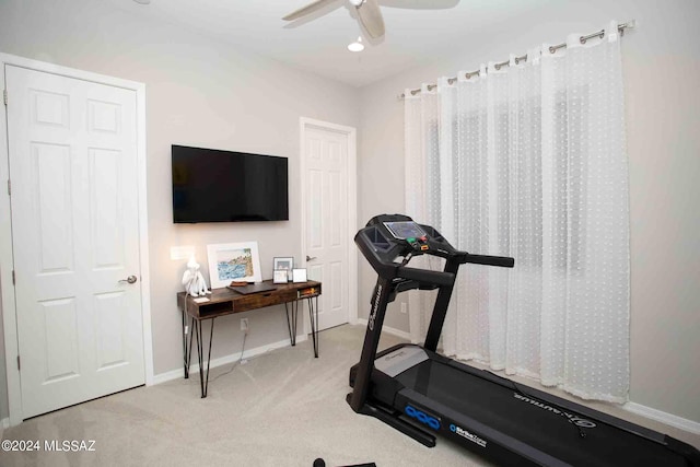 exercise room featuring baseboards, a ceiling fan, and carpet flooring