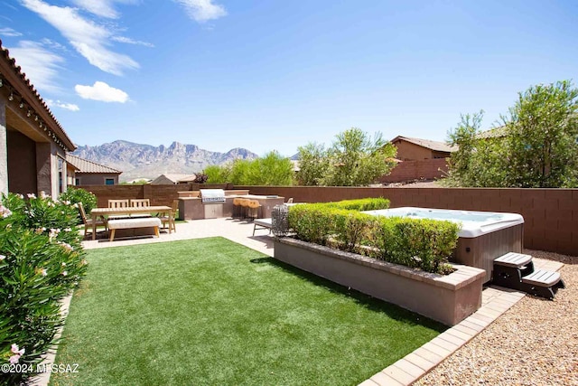 view of yard featuring a patio, a hot tub, and a mountain view