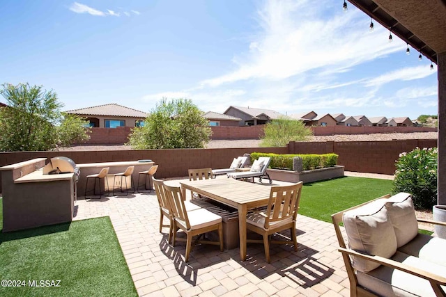 view of patio / terrace with outdoor dry bar, an outdoor hangout area, and a fenced backyard
