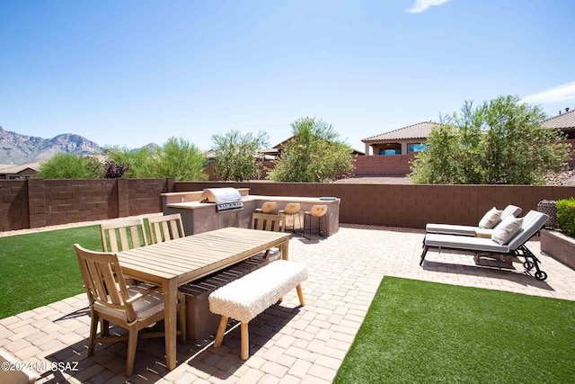 view of patio with outdoor lounge area, a mountain view, and area for grilling