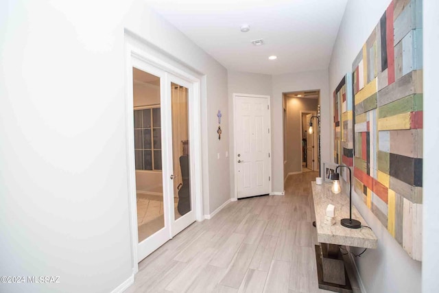 corridor featuring recessed lighting, light wood-type flooring, visible vents, and baseboards