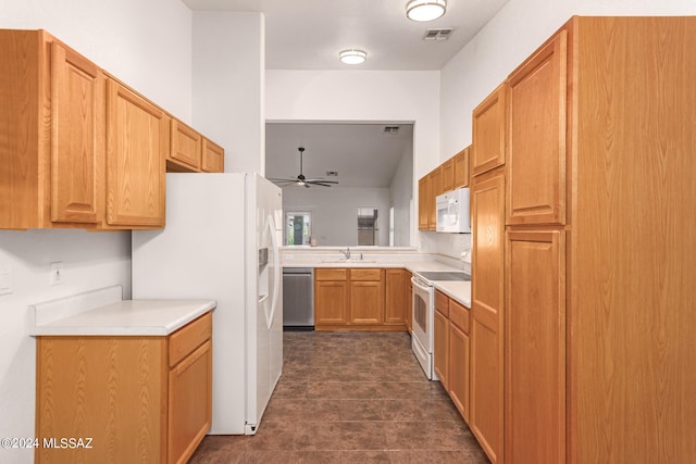 kitchen with dark tile patterned floors, white appliances, ceiling fan, and sink