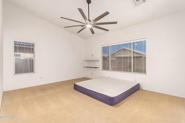 unfurnished bedroom with visible vents, a ceiling fan, carpet floors, and vaulted ceiling