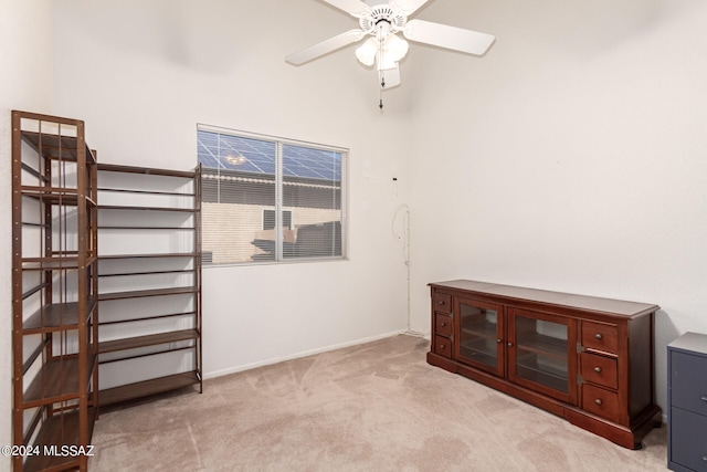 miscellaneous room with ceiling fan and light colored carpet