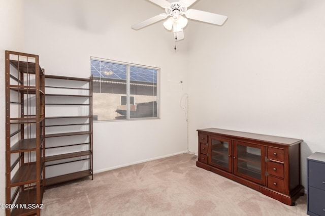 interior space with light carpet and baseboards