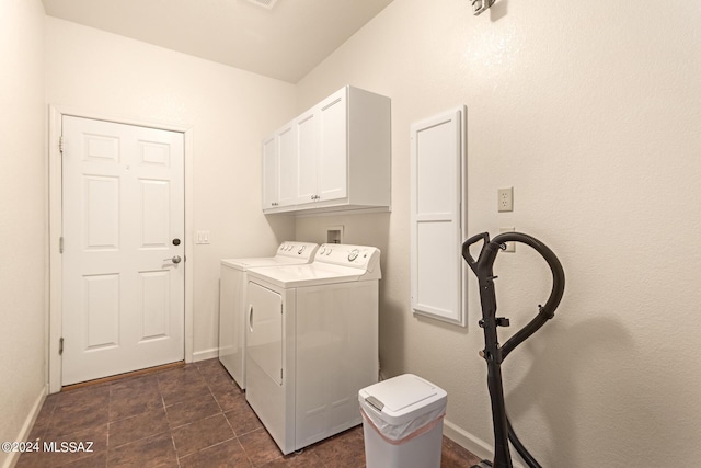 laundry room with washing machine and clothes dryer, cabinet space, and baseboards